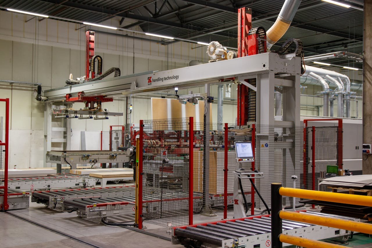about-img Industrial machinery with robotic arm in a modern manufacturing facility.